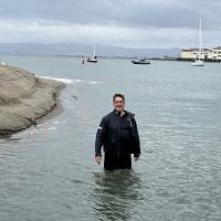 Knarr skipper Mike Ratiani provides some context for the scale of the harbor entrance at low tide on April 25.