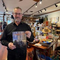 Jeff Battis holds the very last copy of the February issue of Latitude 38 two days before the arrival of the March issue.