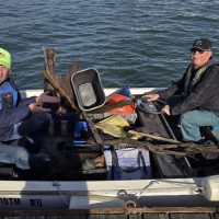 The Mark Set Boat collecting debris from the Estuary prior to the race.