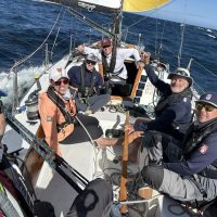 The crew from 'Azure,' sailing under the Encinal Yacht Club burgee, won the 2026 California Offshore Race Week.