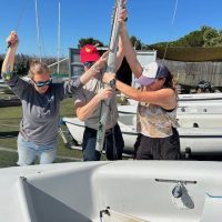 Stepping the mast is a group effort.