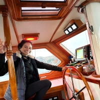 Coxswains mate, Iman, at Cetacea's pilot house helm as we pass under the Gate on Dec 1, SouthBeach, North Bay Sailing Meetup, @kb