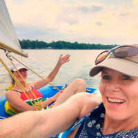 Hello-from-the-unsalted-shores-of-saugatuck-Michigan-lake-Michigan-with-south-African-sailor-Lucia-Earle-at-the-tiller-Santa-Cruz-sailor-christine-currie-french-Mogli-Dingy