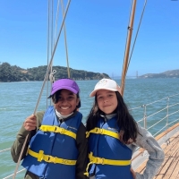 5.	Two campers pose for a picture on Seaward with the Golden Gate Bridge behind them.