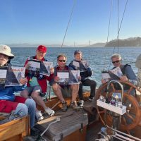 The crew of Kay of Goteborg picked up their copies of the October issue just before heading out last night for an evening sail. Left to right:  Doug Finley, Charlie Bronson, Barry Stompe, Andy Eggler, owner Neil Gibbs, and his daughter Kali Gibbs.