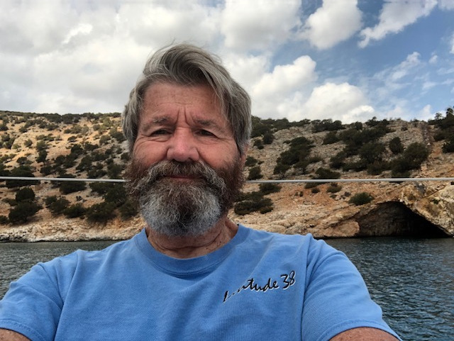 Self-portrait-of-Ron-Harben-last-week-in-a-secluded-cove-on-the-south-end-of-Naxos-Island-in-the-Greek-Cyclades-Rina-Cave-in-the-background.-