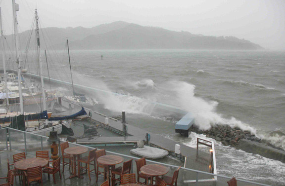 Waves crash over breakwater