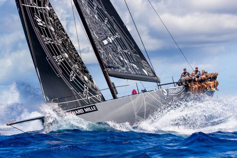 Gray boat splashing through a wave