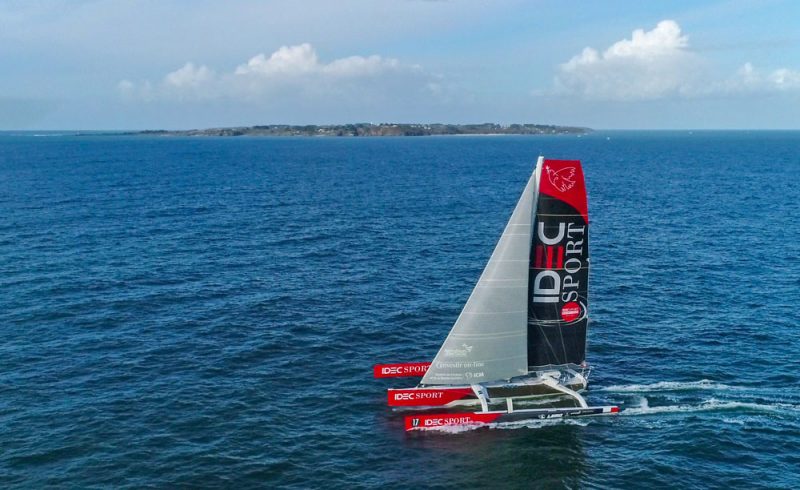 IDEC Sport sails past an island