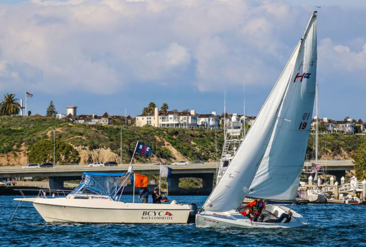 Harbor 20 with race committee boat