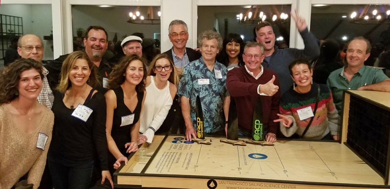 people with wooden table exhibit