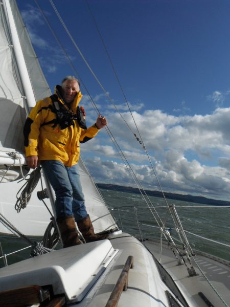 Trevor Steel standing at the mast in foulies