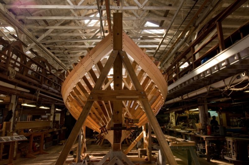 A partially framed boat is under construction at Spaulding Marine Center