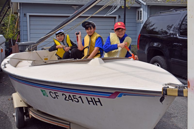 3 boys on a sailing dinghy