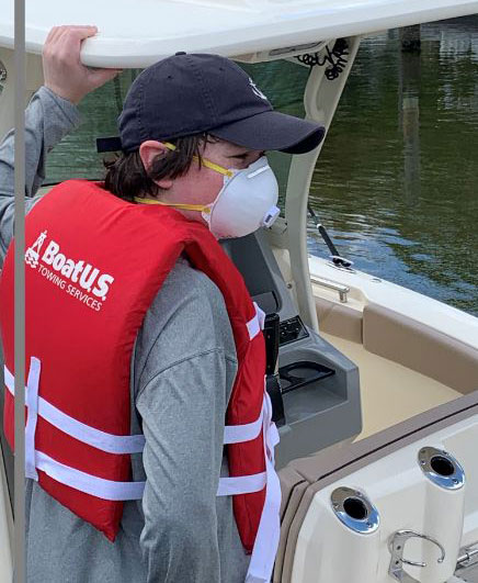 Kid wearing filter mask and PFD