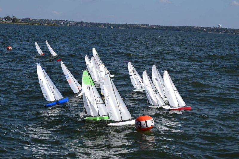 A fleet of DF95 model sailboats races their 2019 North American Championships