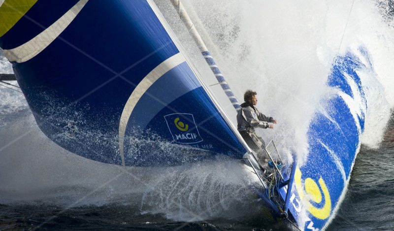 Gabart on the bow of his IMOCA