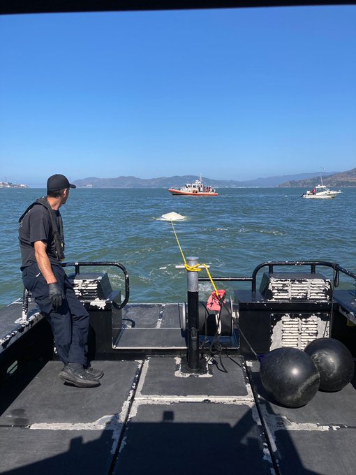 Capsized vessel being towed to port.