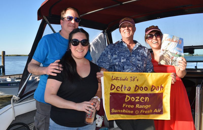 2 couples with Delta Doo Dah flag and magazine