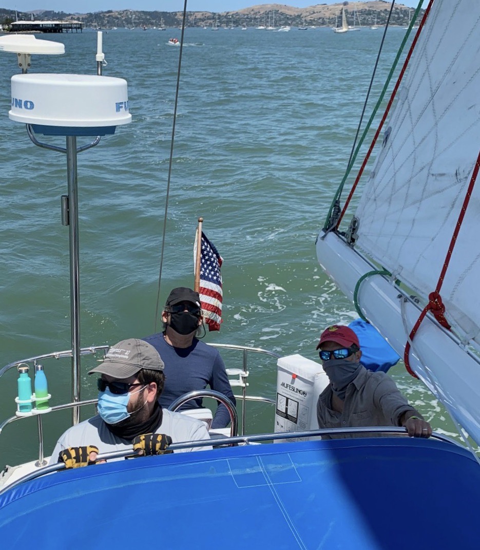 Three sailors in cockpit