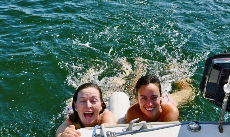 two girls dragging behind a boat