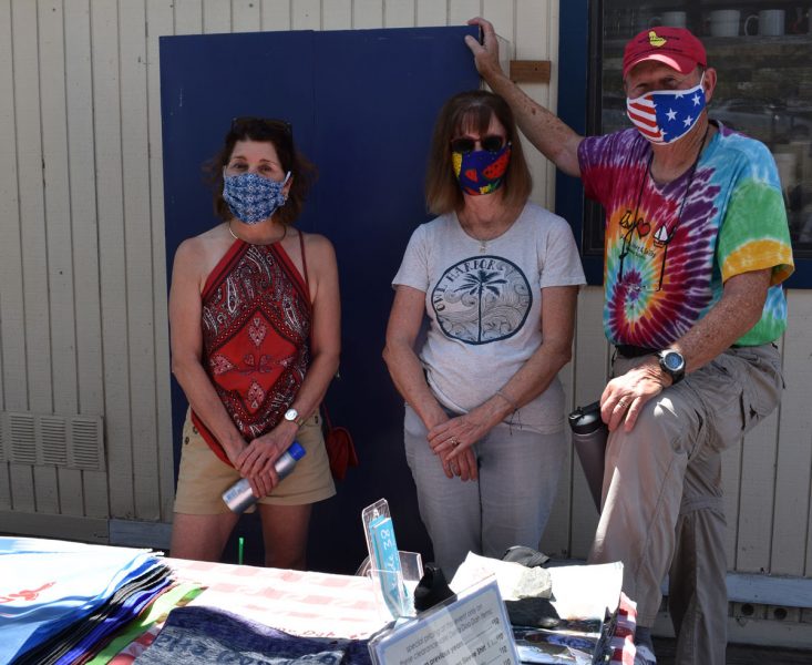 Three people wearing masks