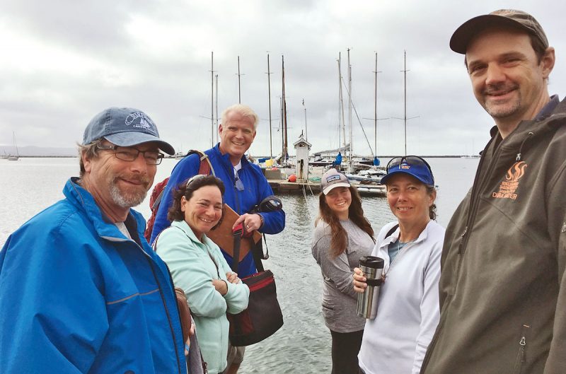 Group of sailors with dock in the background. September racing story.