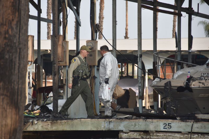 Fish and Wildlife officer and man in Tyvek suit