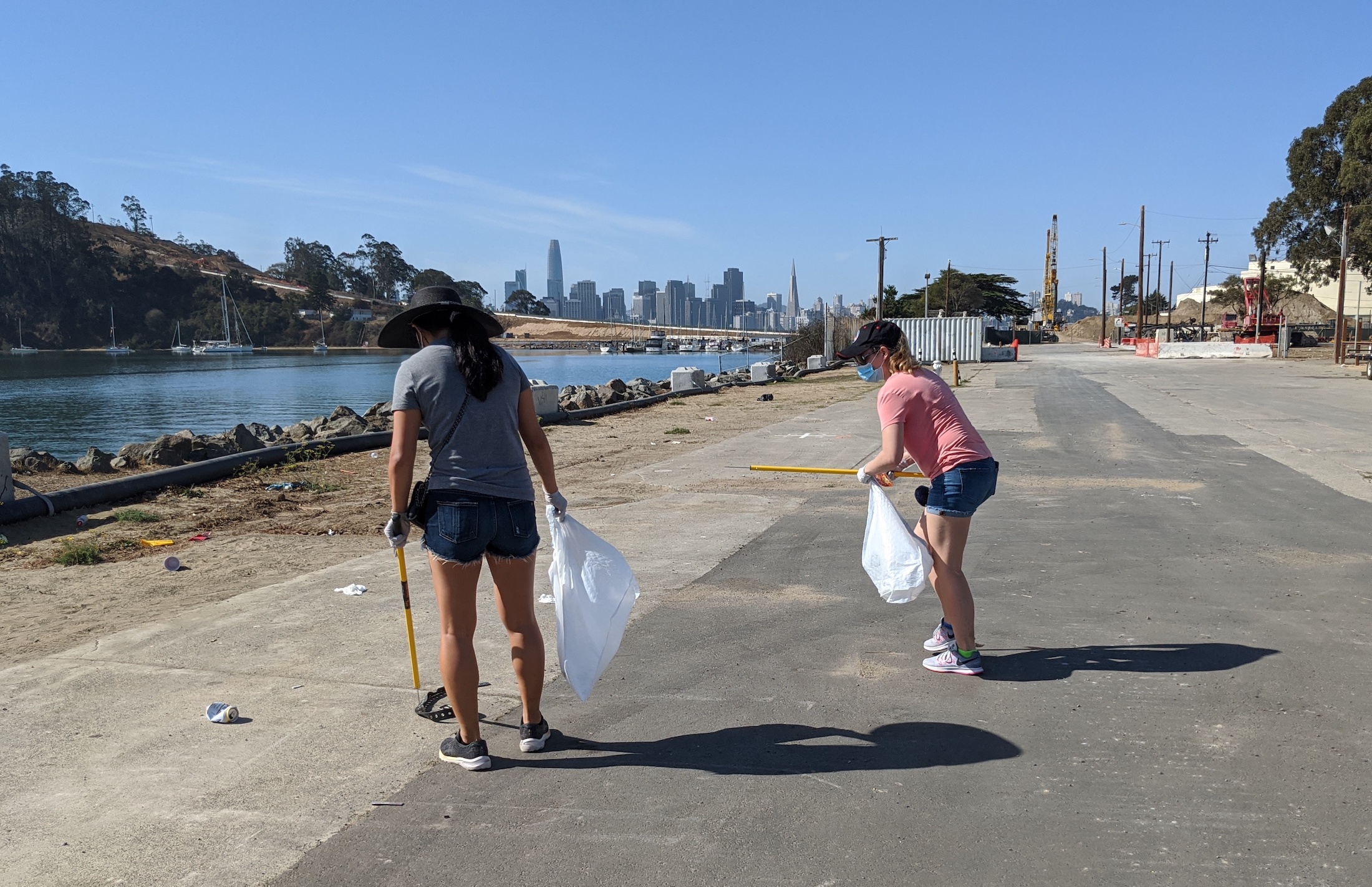 Two volunteers cleaning up at Treasure Island