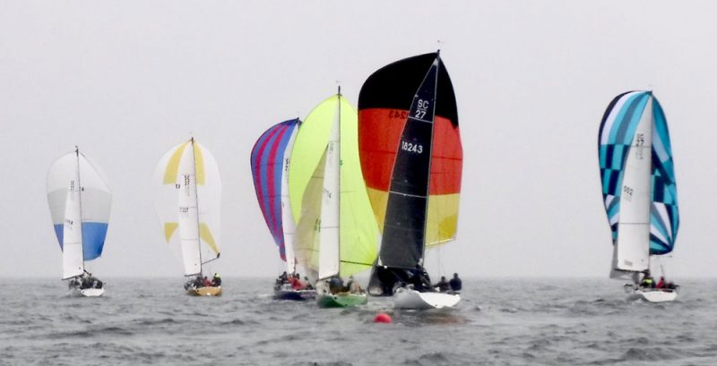 Spinnakers sail away from the offset mark