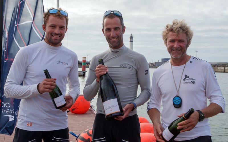 Three men with champagne bottles