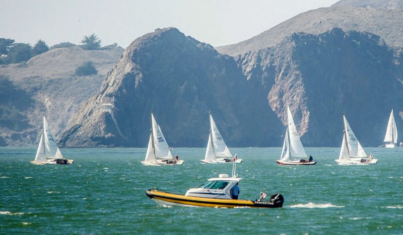 Folkboats sail past the Marin Headlands