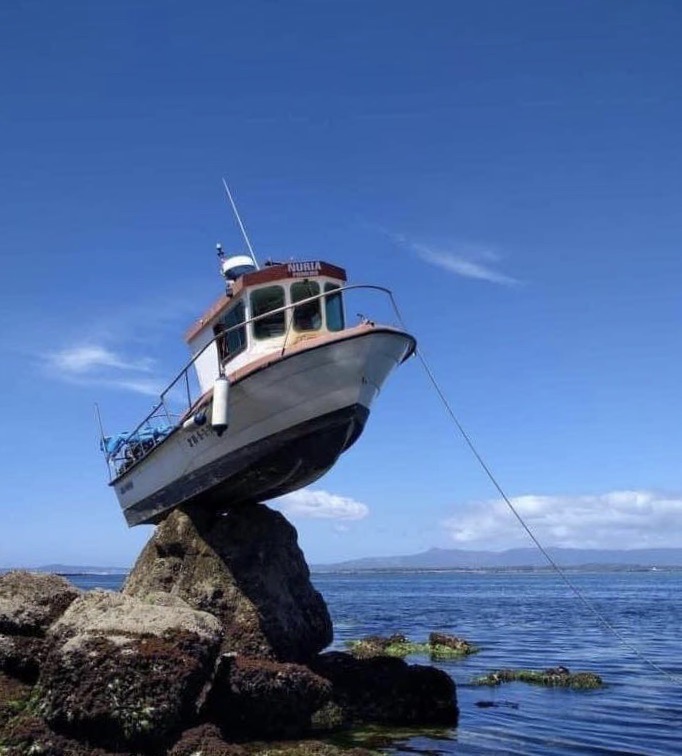 Caption Contest (!) Anchored Boat High and dry on Rock