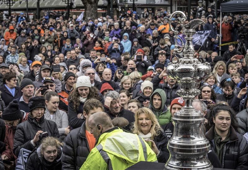 Crowd in the rain with the Cup trophy