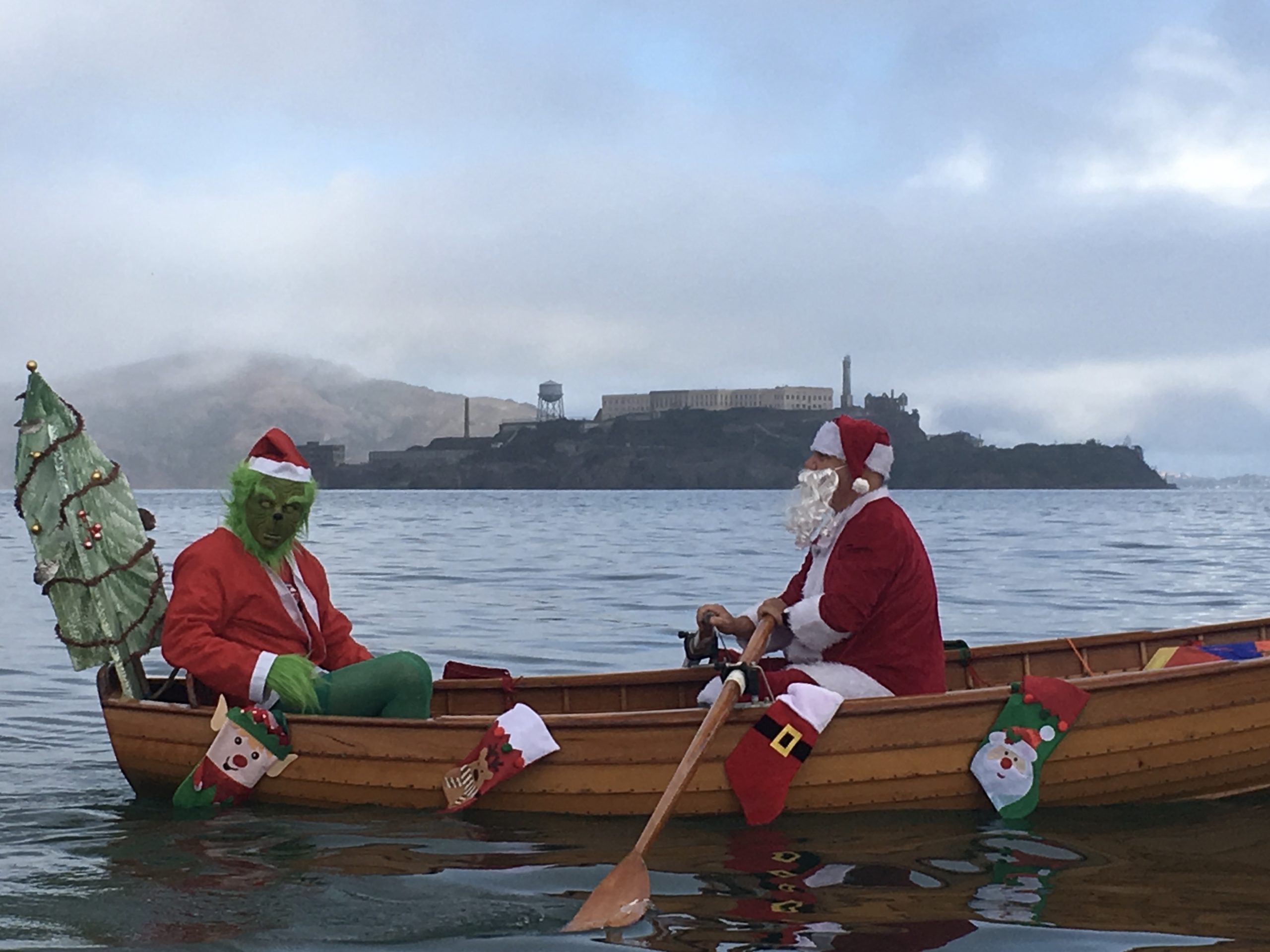 Grinch and Santa rowing