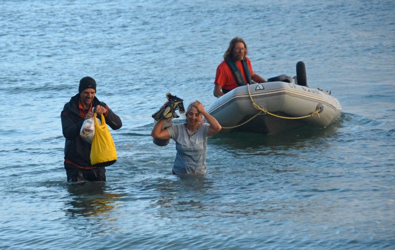 Wading ashore from a dinghy