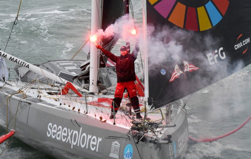 Boris Herrmann at the finish, with flares