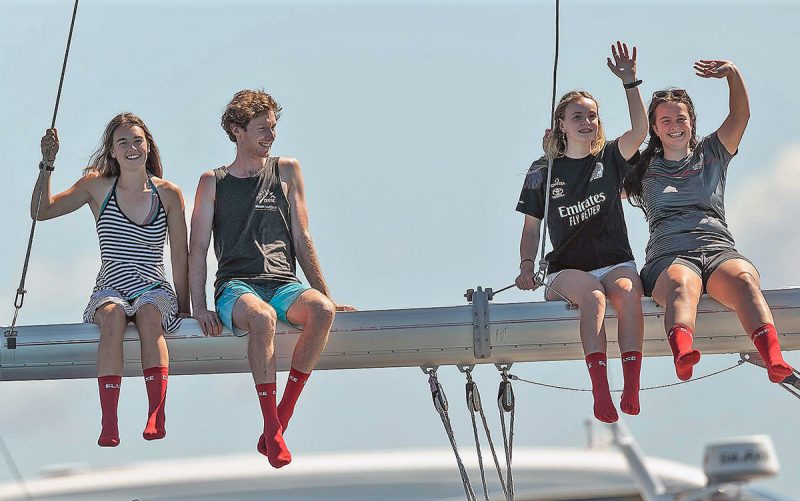 Fans wearing red socks, sitting on a boom