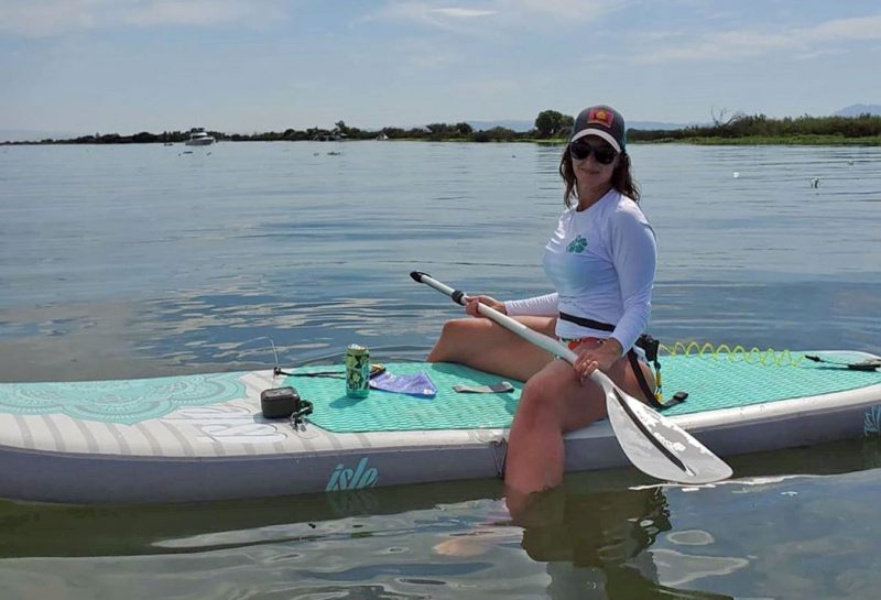 woman sitting on SUP