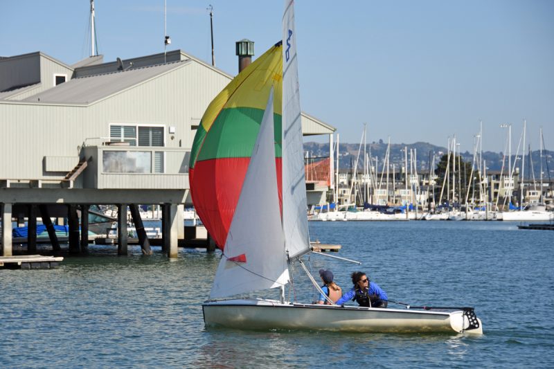 Teenagers in a 420 with spinnaker