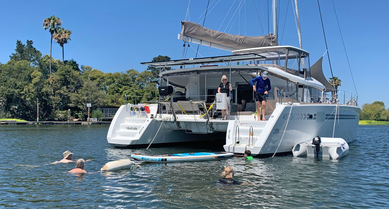 Swimmers off the transom of a cruising cat