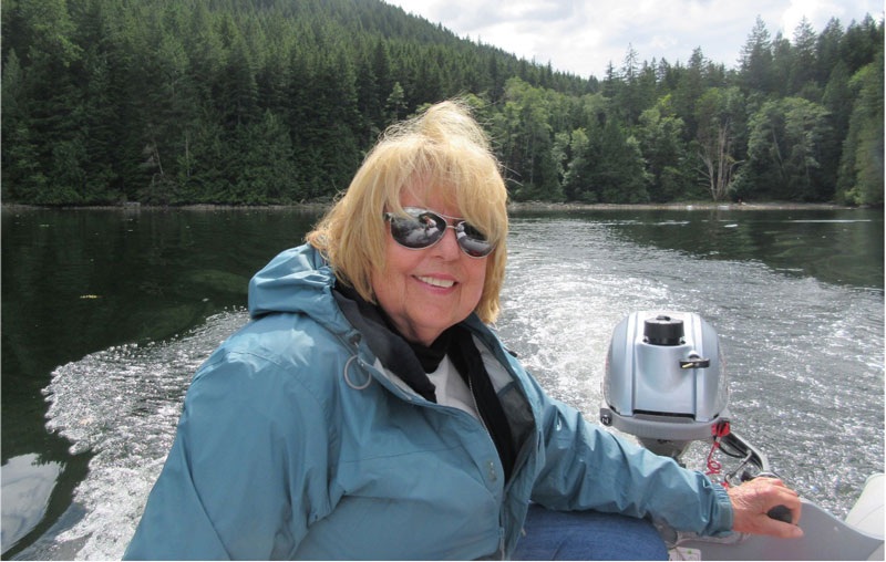 Linda Newland steering an outboard