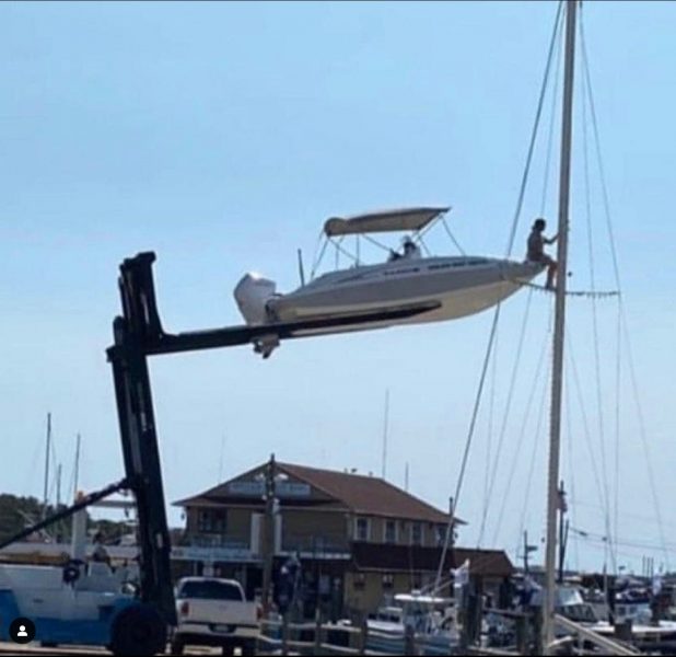 Boat on crane to reach mast