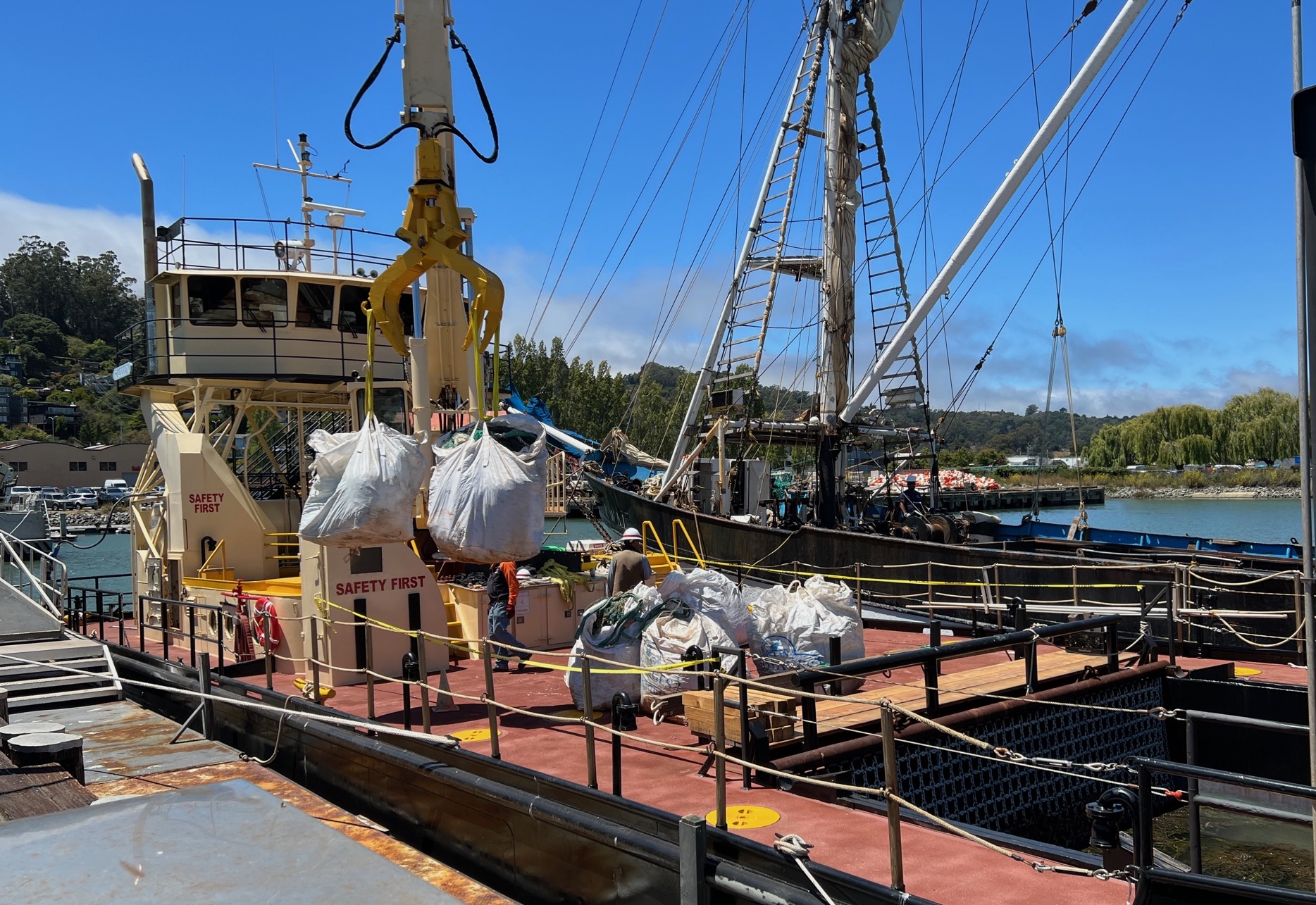 trash being unloaded from barge