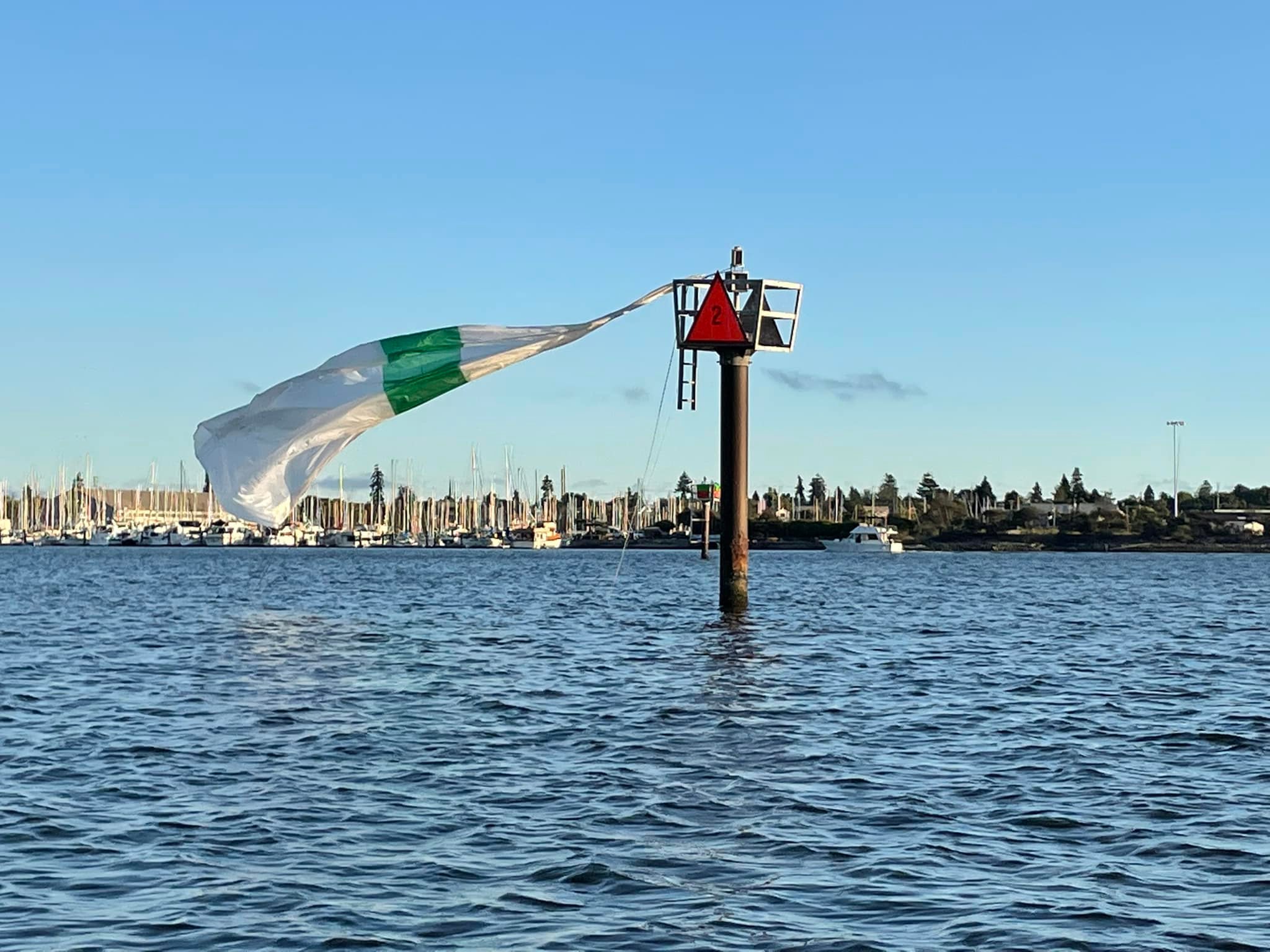 Sail flying from channel markerAugust