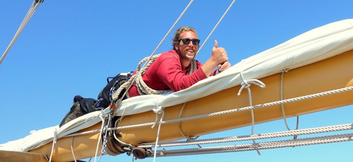 man on sailboat boom