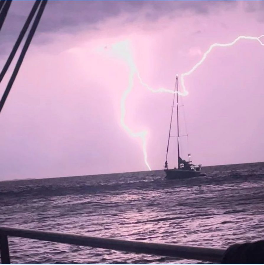 boat under lightning sky