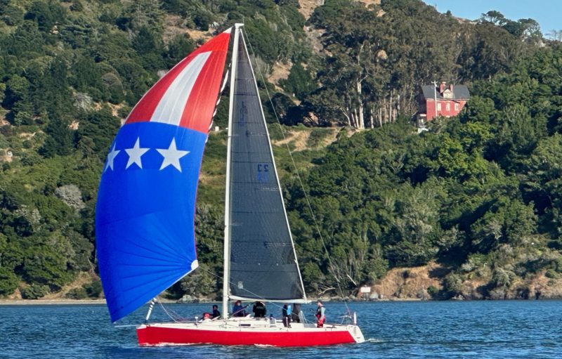 The J/100 'Feather' flying US flag spinnaker.