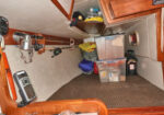 Private quarterberth on starboard - Served as our "garage" for miscellany - but we have the original cushions. Long shelf  stores pump and poles for inflatable out of the way.