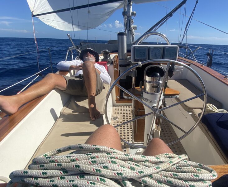 man laying on sailboat